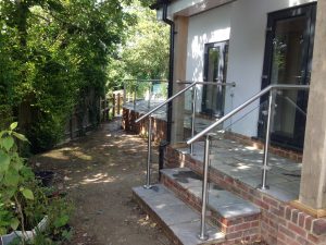 Post and rail glass balustrade to garden